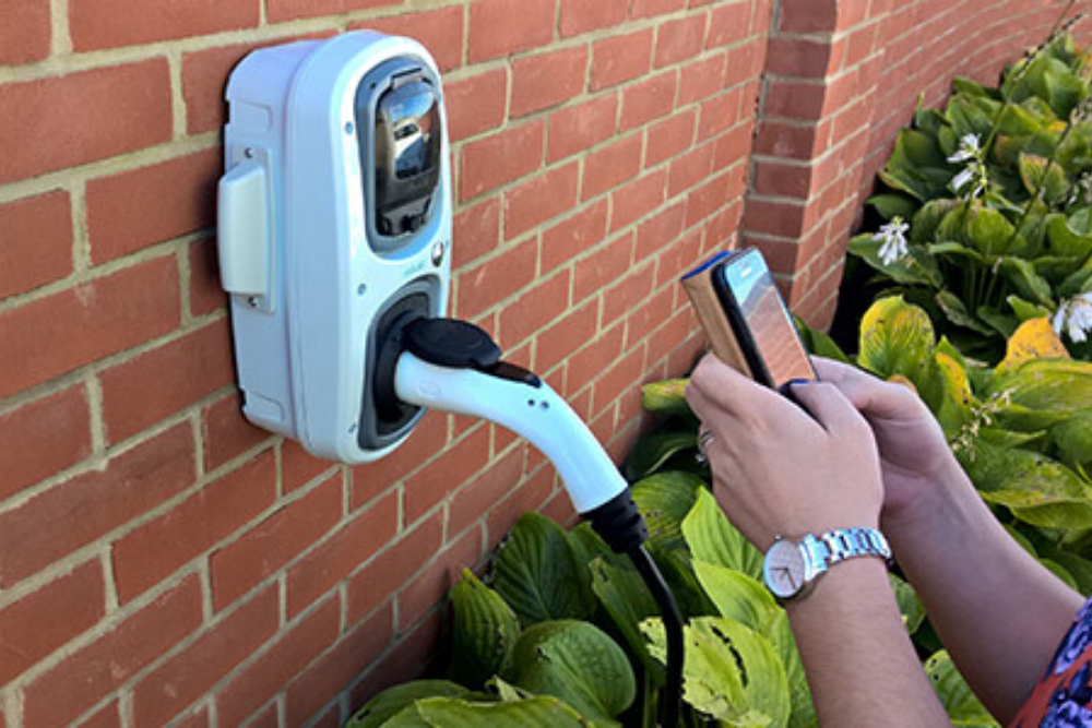rolec_smart_ev_chargepoint RolecEV Smart Chargepoint being used by man with a mobile phone